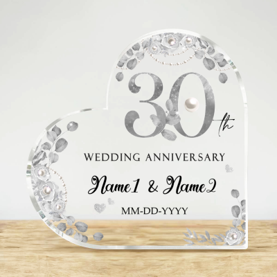 Personalized 30 Year Aanniversary Gift, Pearl Wedding Anniversary Gifts, 30th Wedding Anniversary Acrylic Plaque, Thirty Year Anniversary Keepsake Crafted from high-quality acrylic, this stunning plaque features a timeless heart shape adorned with delicate floral designs, symbolizing growth and blossoming love over the years. The elegant silver-tone "30th" stands prominent, immediately drawing attention to this special day, while the names and wedding date are beautifully personalized for a touch that’s uniquely yours. This acrylic plaque is not just a decoration but a heartfelt reminder of the laughter, challenges, and cherished moments that have woven together the fabric of your life. Measuring just the right size, it fits perfectly on any mantle, bookshelf, or desk, serving as a daily reminder of your enduring commitment. Perfect for surprising your partner or gifting to a beloved couple, this personalized 30th wedding anniversary keepsake speaks volumes of your affection and appreciation. Ideal for anniversaries, it is a gift that will surely be treasured for years to come. Make this memorable occasion even more special with a gift that encapsulates the magic of your enduring love. Order your personalized anniversary plaque today and celebrate the beautiful milestone of 30 years together!